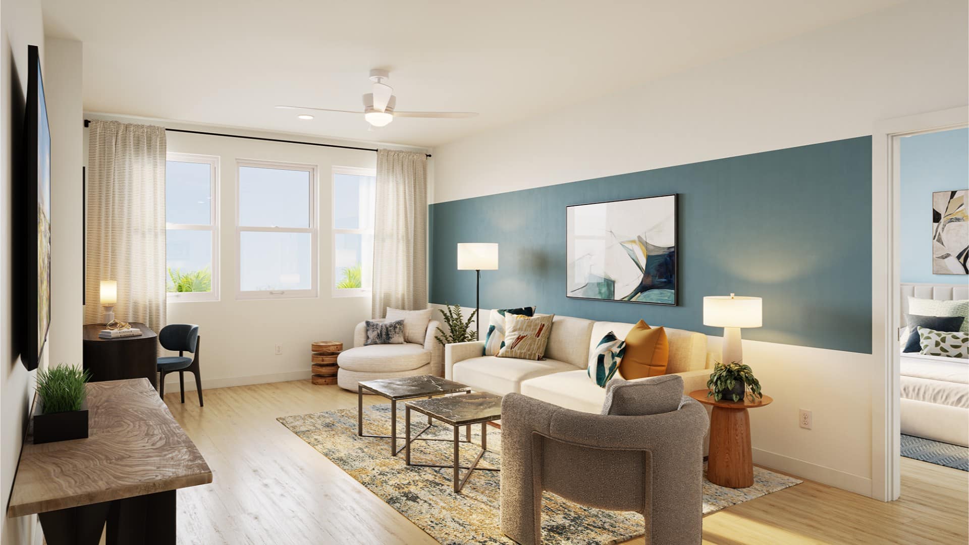 Modern living room with a blue accent wall, sofa, armchairs, coffee tables, rug, lamps, and large windows; a bedroom is visible through an open door.